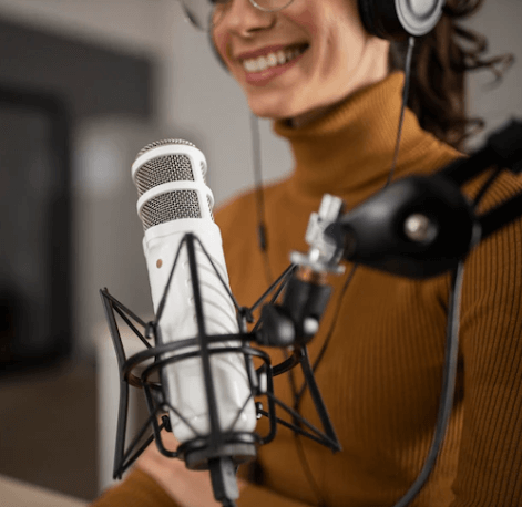 A woman recording her voice in a radio studio
